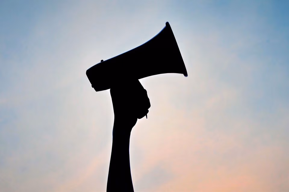 OP megaphone silhouette against a pink and blue sky can be used for speaking out equal rights freedom